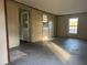 Open living room featuring ample space and two bright windows, perfect for customization at 144 Flat Rock Rd, Oxford, GA 30054