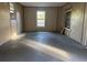 Spacious living room with natural light pouring in through multiple windows and paneled walls at 144 Flat Rock Rd, Oxford, GA 30054