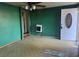 View of a living room featuring green walls, a ceiling fan, and a white front door at 144 Flat Rock Rd, Oxford, GA 30054