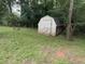 A weathered shed in the backyard offers extra storage space at 144 Flat Rock Rd, Oxford, GA 30054