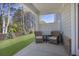 View of a covered back patio with two chairs, a side table and outdoor green space at 2540 Ravencliff Dr # 155, Austell, GA 30168
