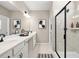 Bathroom features a dual sink vanity with black hardware, a walk-in shower, and decorative artwork at 2540 Ravencliff Dr # 155, Austell, GA 30168