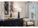 A well-lit bedroom offers a black dresser, lamp, and chair near a window with stylish curtains at 2540 Ravencliff Dr # 155, Austell, GA 30168