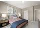 Bedroom showcasing a cozy bed, artwork, and ample natural light from the window at 2540 Ravencliff Dr # 155, Austell, GA 30168