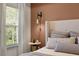 Comfortable bedroom with large window and stylish decor and bedside table with sconce lighting at 2540 Ravencliff Dr # 155, Austell, GA 30168