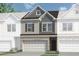Charming townhome featuring a two-car garage, and attractive brick and siding exterior at 2540 Ravencliff Dr # 155, Austell, GA 30168