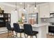 Modern kitchen with stainless steel appliances, island seating, and gray backsplash at 2540 Ravencliff Dr # 155, Austell, GA 30168