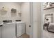 Laundry room with new appliances, and wire shelving, with bedroom access at 2540 Ravencliff Dr # 155, Austell, GA 30168