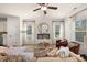 Comfortable living room featuring an electric fireplace, windows with sheer curtains, and stylish furnishings at 2540 Ravencliff Dr # 155, Austell, GA 30168