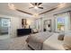Beautiful main bedroom with tray ceiling, ceiling fan, bedside table, and ensuite bathroom access at 2540 Ravencliff Dr # 155, Austell, GA 30168