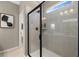 A glass-enclosed shower showcases neutral tile work, a window, and black hardware fixtures at 2540 Ravencliff Dr # 155, Austell, GA 30168
