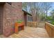 Private backyard deck featuring a brick exterior and a wooden planter, perfect for outdoor relaxation and gatherings at 3916 S Martin Way, Lithia Springs, GA 30122