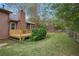 Spacious backyard with a deck, manicured lawn, shed, and privacy fence at 3916 S Martin Way, Lithia Springs, GA 30122