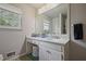 Bright bathroom featuring a marble countertop, white vanity, and a window at 3916 S Martin Way, Lithia Springs, GA 30122