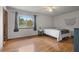 Cozy bedroom with hardwood floors, large window offering natural light, and minimalist decor, perfect for relaxation at 3916 S Martin Way, Lithia Springs, GA 30122