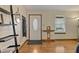 Bright foyer featuring hardwood floors, a decorative front door, and modern shelving at 3916 S Martin Way, Lithia Springs, GA 30122