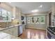 Bright kitchen with granite countertops, stainless steel appliances, and a view of the backyard through the windows at 3916 S Martin Way, Lithia Springs, GA 30122