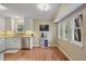 Bright kitchen boasts white cabinets, stainless steel appliances, and hardwood floors at 3916 S Martin Way, Lithia Springs, GA 30122