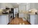 Modern kitchen with granite countertops, stainless steel appliances, and sleek white cabinetry, great for cooking at 3916 S Martin Way, Lithia Springs, GA 30122