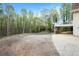 View of wooded lot behind house with parking area and covered storage at 5732 Falls View Dr, Buford, GA 30518