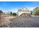 Rear view of house with parking area, and wooded backdrop at 5732 Falls View Dr, Buford, GA 30518