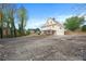 Rear view of yellow house with walkout basement and parking area at 5732 Falls View Dr, Buford, GA 30518