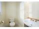 Half bathroom featuring a white toilet, white sink, and neutral walls at 5732 Falls View Dr, Buford, GA 30518