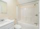 Bright bathroom featuring a white vanity, toilet, and a shower-tub combination at 5732 Falls View Dr, Buford, GA 30518