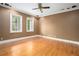 This bedroom boasts hardwood floors, neutral walls, and natural light from the two large windows at 5732 Falls View Dr, Buford, GA 30518