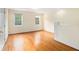 Bright bedroom features hardwood floors, neutral walls, and natural light from the two large windows at 5732 Falls View Dr, Buford, GA 30518