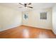 Bedroom with hardwood flooring, ceiling fan, and natural lighting at 5732 Falls View Dr, Buford, GA 30518