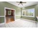 Spacious dining room featuring tile floors, neutral walls, large windows, and views to the outside at 5732 Falls View Dr, Buford, GA 30518