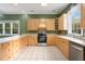 Spacious kitchen with wooden cabinets, tile floors, and stainless steel oven at 5732 Falls View Dr, Buford, GA 30518