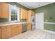 Bright kitchen featuring stainless steel appliances, wooden cabinets, and tile floors at 5732 Falls View Dr, Buford, GA 30518