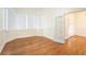 Bright living room featuring hardwood floors, neutral walls, large windows, and classic architectural details at 5732 Falls View Dr, Buford, GA 30518