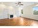 Spacious main bedroom featuring hardwood floors, fireplace, and lots of natural light from large windows at 5732 Falls View Dr, Buford, GA 30518