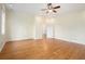 Spacious main bedroom featuring hardwood floors, neutral walls, large windows, and ceiling fan at 5732 Falls View Dr, Buford, GA 30518