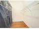 Walk-in closet featuring wood floors and a metal rack along the wall at 5732 Falls View Dr, Buford, GA 30518