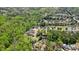 Aerial view of the home in a wooded community near other homes and neighborhoods and surrounded by trees at 1010 Allenbrook Ln, Roswell, GA 30075