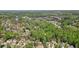 An aerial view shows the surrounding community of a two-story home with a well-kept lawn and a driveway at 1010 Allenbrook Ln, Roswell, GA 30075