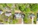An aerial view highlighting the roofline of a two-story home with dormer windows in a wooded area at 1010 Allenbrook Ln, Roswell, GA 30075