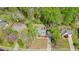 An aerial view shows a two-story home with mature trees, a well-kept lawn, and a long driveway at 1010 Allenbrook Ln, Roswell, GA 30075