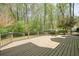 The backyard deck is ready for entertaining with railing and a view of the wooded backyard at 1010 Allenbrook Ln, Roswell, GA 30075