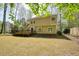 Expansive backyard showcases a wooden deck and mature trees, offering a serene outdoor space at 1010 Allenbrook Ln, Roswell, GA 30075