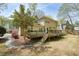 Beautifully landscaped backyard featuring a wooden deck and mature flowering tree at 1010 Allenbrook Ln, Roswell, GA 30075