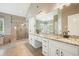 Bright bathroom with dual vanity, granite counters and glass enclosed shower at 1010 Allenbrook Ln, Roswell, GA 30075
