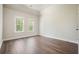 Bedroom with hardwood floors, natural light, and neutral walls at 1010 Allenbrook Ln, Roswell, GA 30075