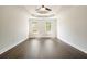 Bedroom featuring hardwood floors, tray ceiling, and natural light at 1010 Allenbrook Ln, Roswell, GA 30075