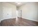 Spacious bedroom featuring wood floors, closet and neutral paint at 1010 Allenbrook Ln, Roswell, GA 30075