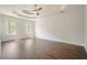 Spacious bedroom with tray ceiling, hardwood floors and natural light at 1010 Allenbrook Ln, Roswell, GA 30075